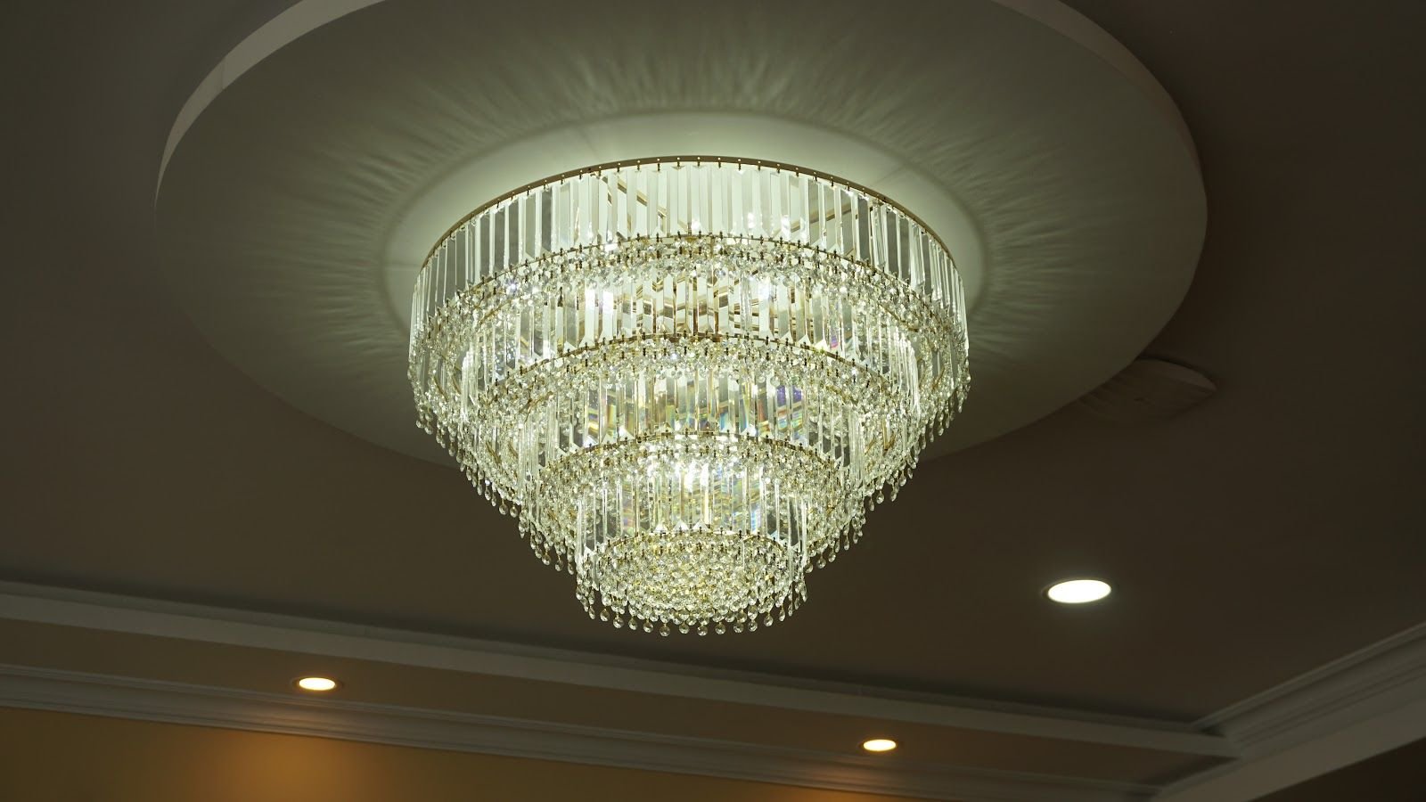 A large tiered glass chandelier on the ceiling