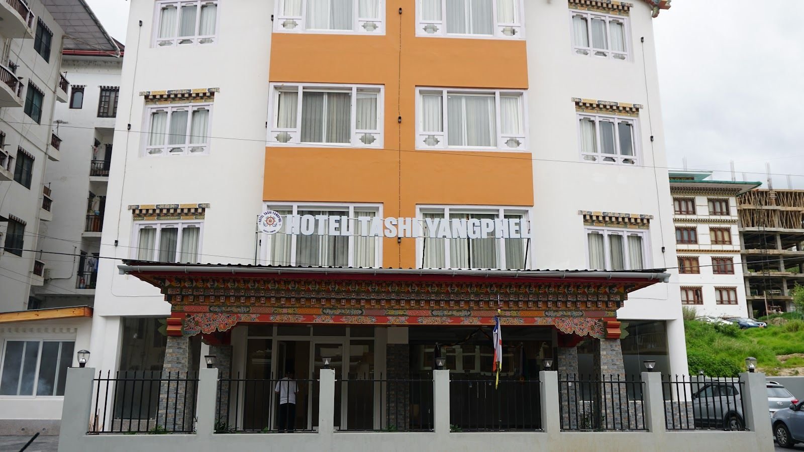 The hotel and its gate seen from across the road