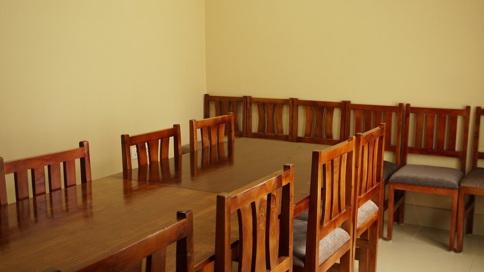 Hardwood chairs drawn up to the tables in the function room