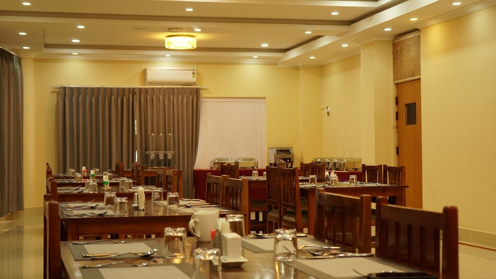 Laid tables and carved wooden chairs in the restaurant