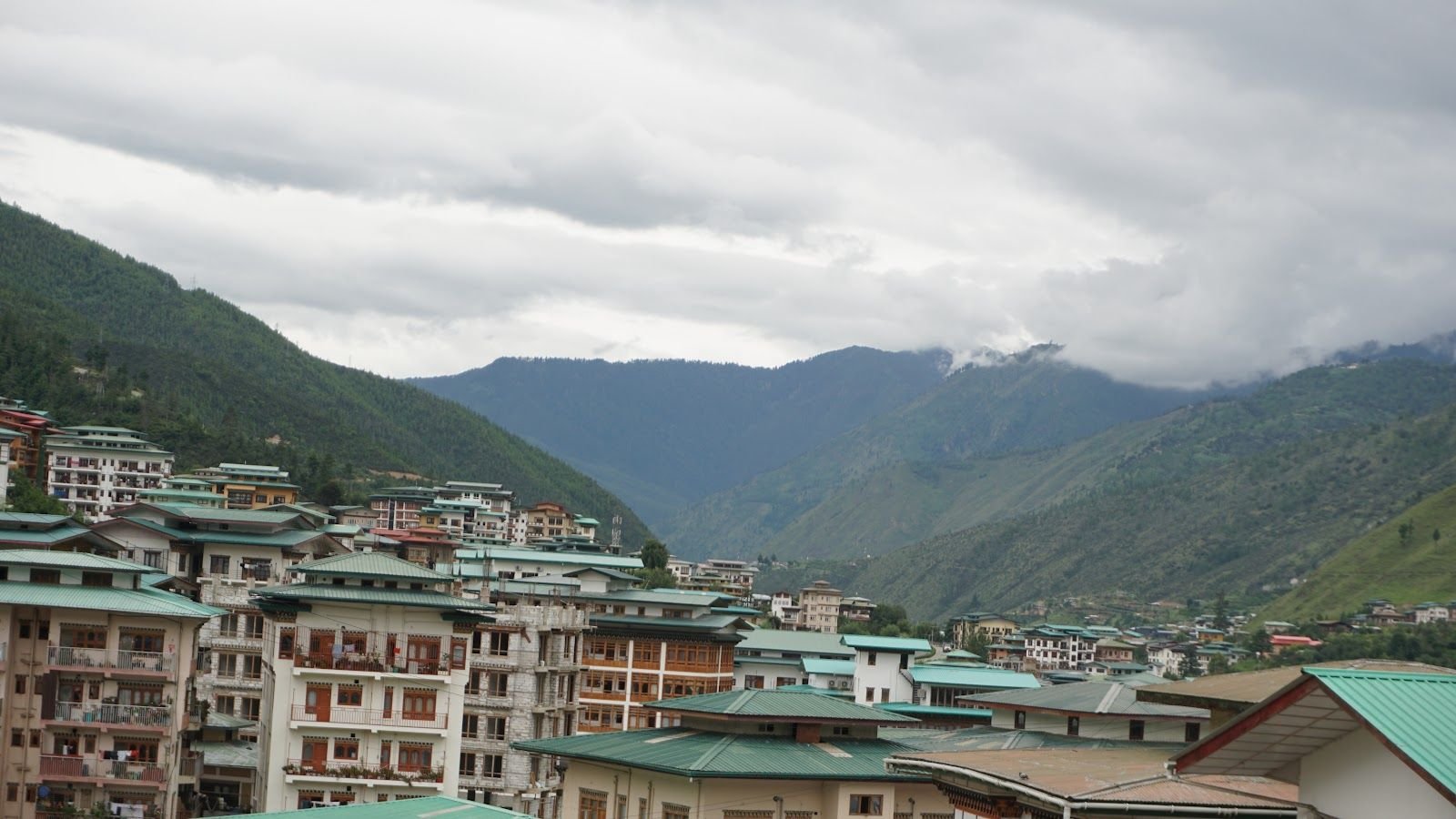 The valley and its forested ridgeline seen from the hotel, low cloud over the tops